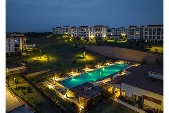 evening view of the resort-inspired swimming pool at Reveal Skyline apartments
